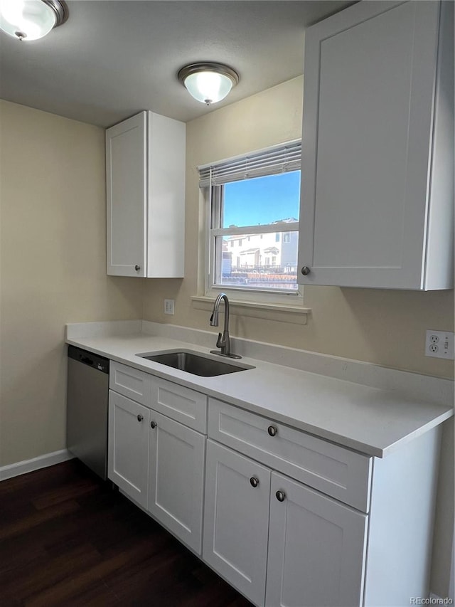 kitchen with dishwasher, dark hardwood / wood-style flooring, white cabinetry, and sink