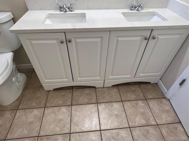 bathroom featuring tile patterned flooring, vanity, and toilet