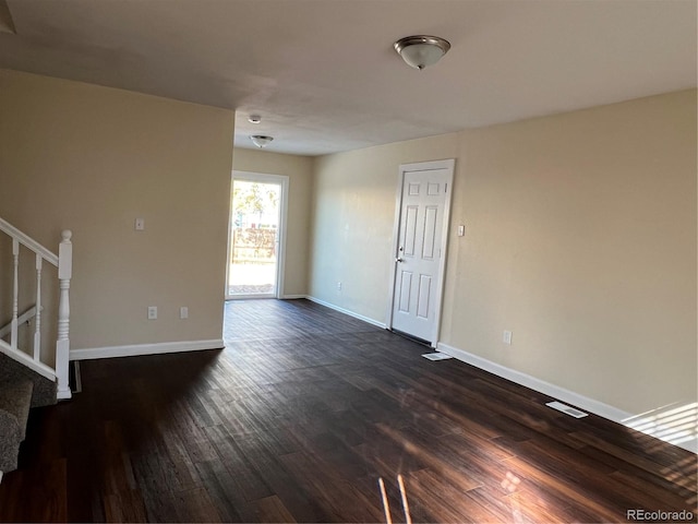 spare room featuring dark hardwood / wood-style floors