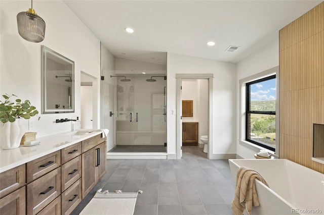 full bathroom featuring tile patterned floors, toilet, separate shower and tub, vaulted ceiling, and vanity