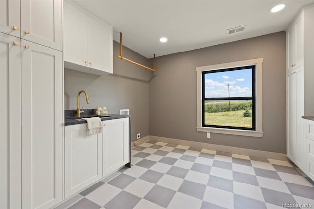 laundry room with cabinets, hookup for a washing machine, and sink