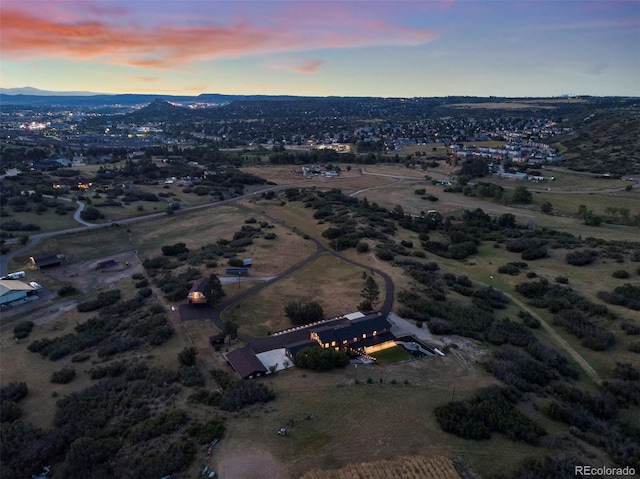 aerial view at dusk featuring a mountain view