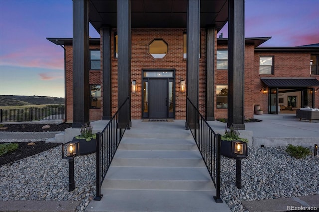 exterior entry at dusk with a porch