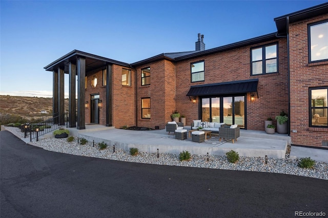 rear view of property featuring outdoor lounge area and a patio