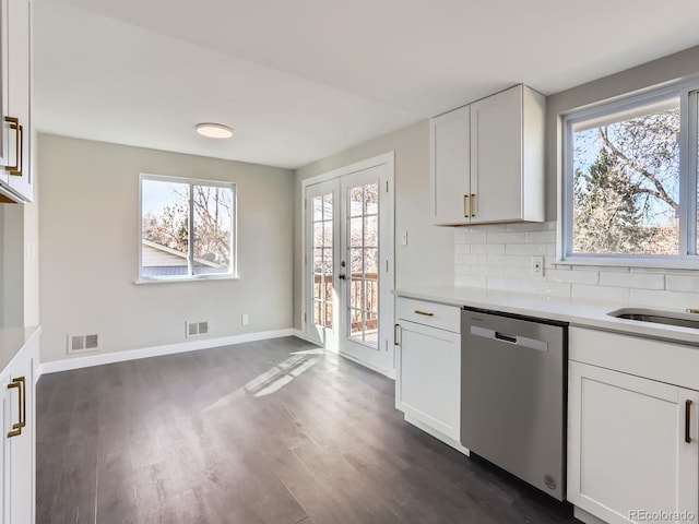 kitchen with tasteful backsplash, visible vents, dishwasher, and light countertops