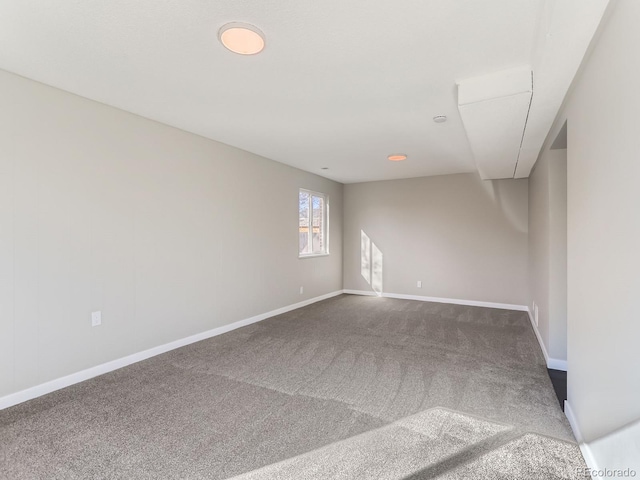 carpeted empty room with baseboards