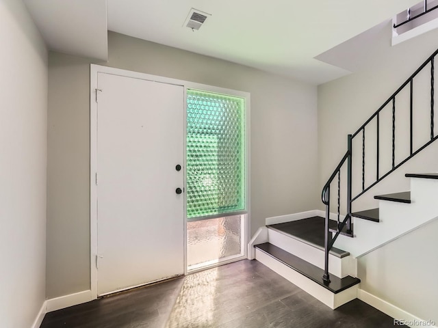 entryway with a wealth of natural light, visible vents, and wood finished floors