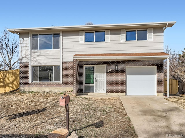 traditional-style house with an attached garage, fence, brick siding, and driveway