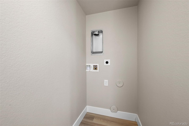 laundry room with hookup for an electric dryer, gas dryer hookup, baseboards, hookup for a washing machine, and wood finished floors