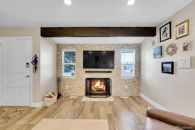 3561 W 131st Ave, Broomfield, CO 80020 - living area with baseboards, a fireplace with flush hearth, wood finished floors, beamed ceiling, and recessed lighting