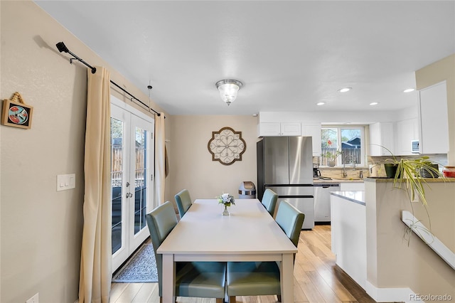 3561 W 131st Ave, Broomfield, CO 80020 - dining room with light wood-type flooring, recessed lighting, and french doors