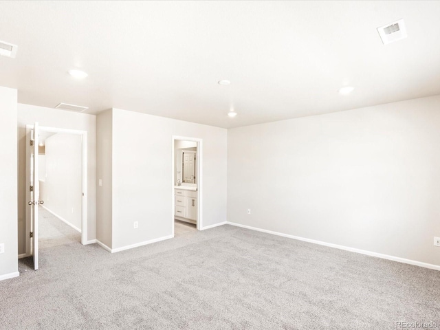 unfurnished bedroom with light carpet, baseboards, visible vents, and recessed lighting