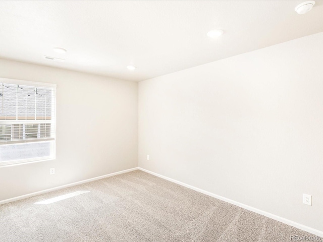 unfurnished room featuring carpet floors, recessed lighting, visible vents, and baseboards