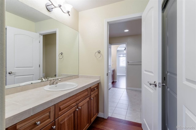 bathroom with vanity, tile patterned floors, and baseboards