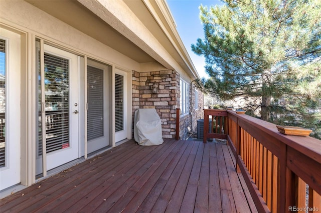 wooden deck with central air condition unit