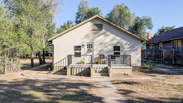 rear view of property with a wooden deck