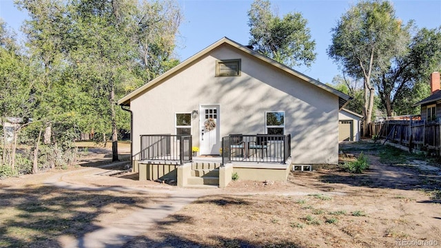 back of house featuring a wooden deck