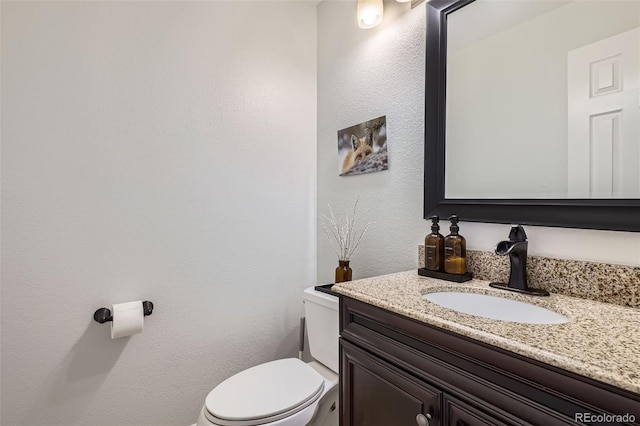 bathroom with toilet and vanity