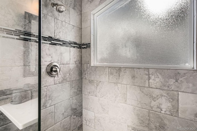 bathroom with a tile shower