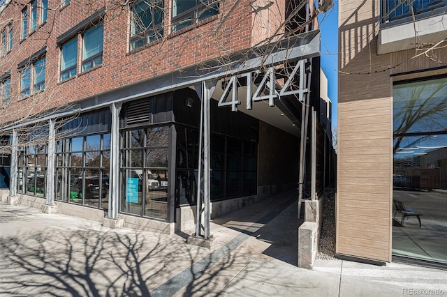 property entrance featuring brick siding