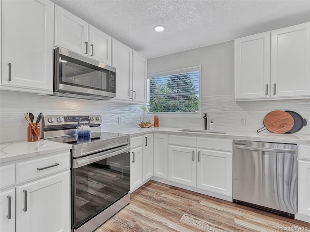 kitchen featuring sink, white cabinets, and stainless steel appliances