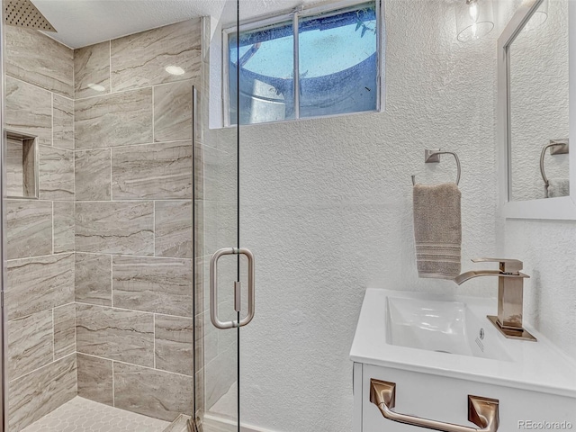 bathroom featuring vanity and an enclosed shower