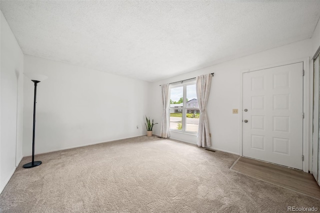 10007 Bryant St, Denver, CO 80260 - entryway with carpet flooring and a textured ceiling