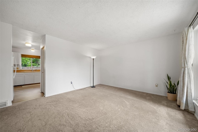 10007 Bryant St, Denver, CO 80260 - unfurnished room featuring light carpet, a textured ceiling, and a sink
