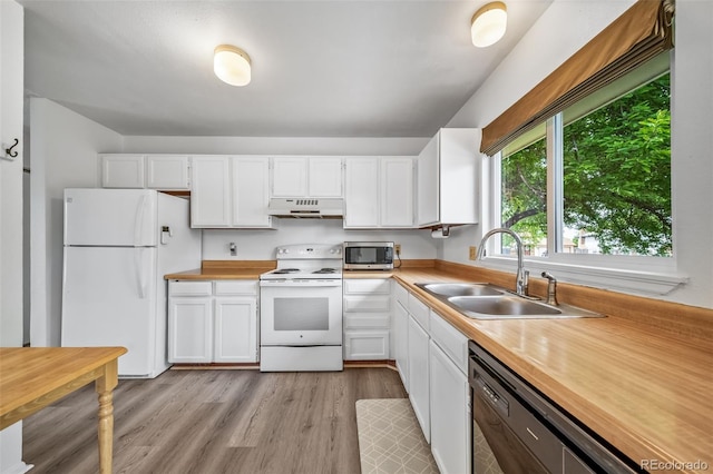 10007 Bryant St, Denver, CO 80260 - kitchen featuring white appliances, under cabinet range hood, a sink, and white cabinets