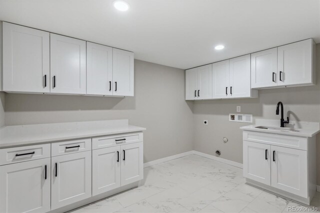 laundry area featuring cabinets, sink, hookup for an electric dryer, hookup for a gas dryer, and washer hookup