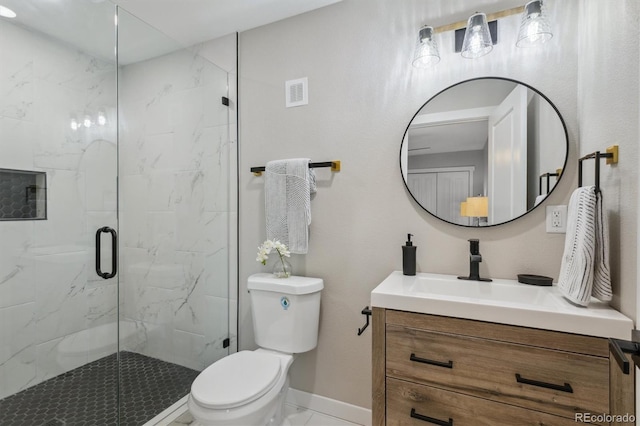 bathroom with vanity, toilet, and an enclosed shower