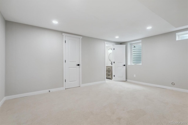 basement featuring a healthy amount of sunlight and light colored carpet