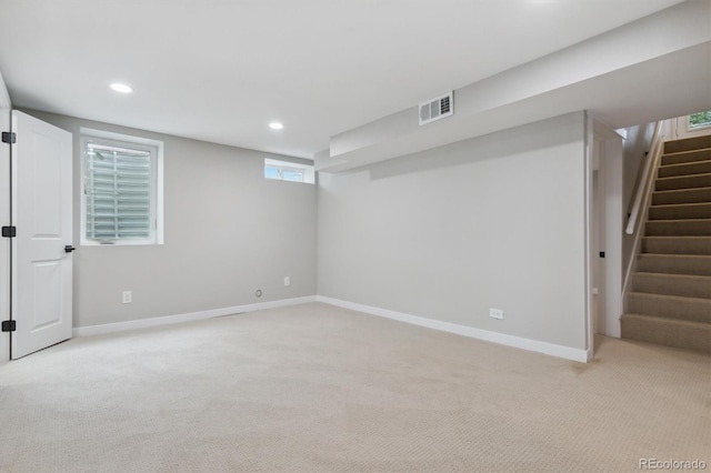 basement featuring light colored carpet