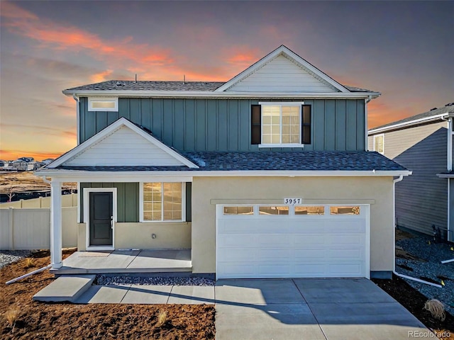 3889 N Shawee St, Aurora, CO 80019 - traditional-style home featuring board and batten siding, an attached garage, concrete driveway, and a shingled roof