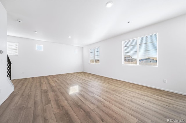 3889 N Shawee St, Aurora, CO 80019 - empty room with plenty of natural light, light wood-type flooring, baseboards, and recessed lighting