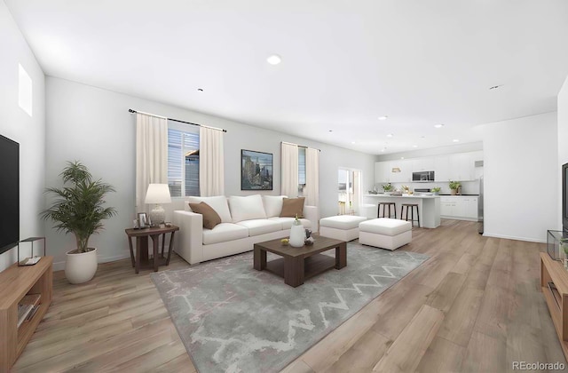 3889 N Shawee St, Aurora, CO 80019 - living room featuring light wood-style floors, plenty of natural light, recessed lighting, and baseboards