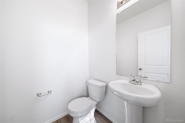 3889 N Shawee St, Aurora, CO 80019 - bathroom featuring toilet, wood finished floors, and baseboards