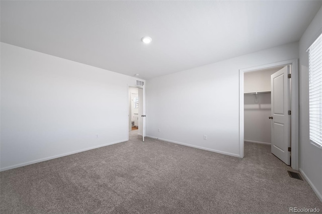 3889 N Shawee St, Aurora, CO 80019 - unfurnished bedroom featuring carpet flooring, a walk in closet, baseboards, and recessed lighting