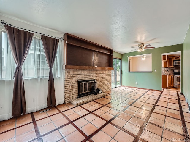 4032 S Atchison Way, Aurora, CO 80014 - unfurnished living room featuring ceiling fan, a fireplace, and light tile patterned floors