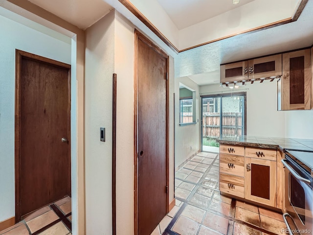 4032 S Atchison Way, Aurora, CO 80014 - kitchen featuring tile counters, stainless steel electric range oven, and inlaid floor details