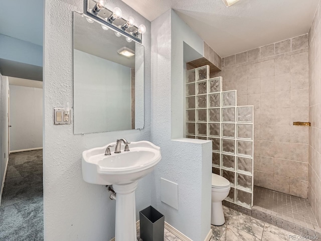 4032 S Atchison Way, Aurora, CO 80014 - bathroom featuring a walk in shower and a textured wall