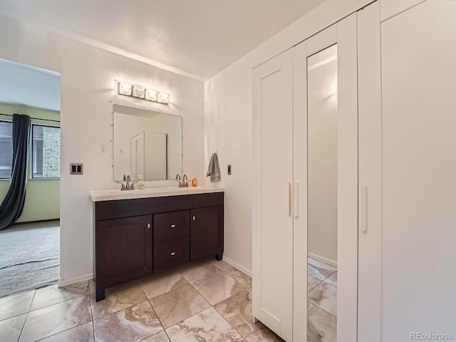 4032 S Atchison Way, Aurora, CO 80014 - bathroom featuring double vanity and baseboards