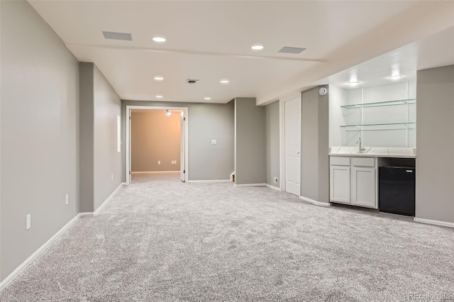 interior space featuring fridge, light colored carpet, recessed lighting, wet bar, and baseboards