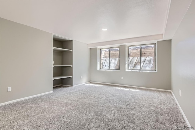 unfurnished room featuring baseboards and carpet floors