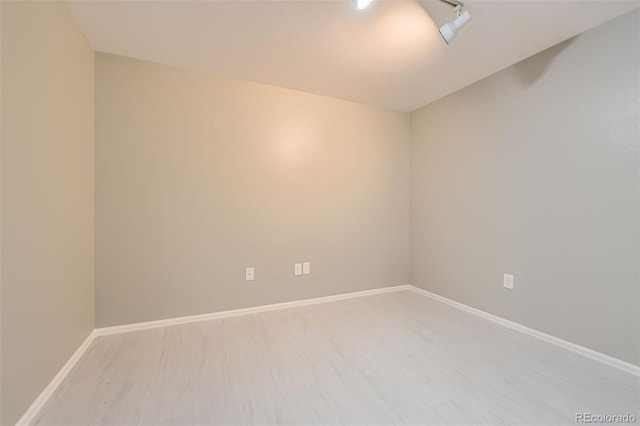 unfurnished room with baseboards