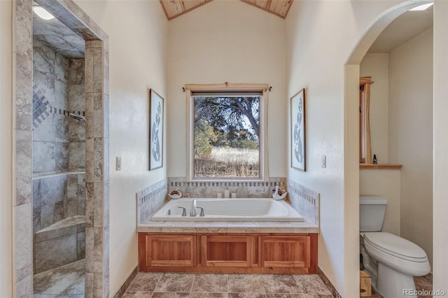 bathroom featuring lofted ceiling, toilet, and separate shower and tub