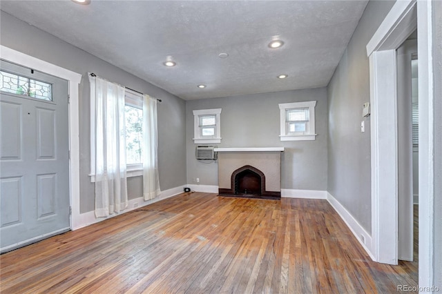 3336 N Saint Paul St, Denver, CO 80205 - unfurnished living room featuring hardwood / wood-style flooring, a fireplace, baseboards, and recessed lighting