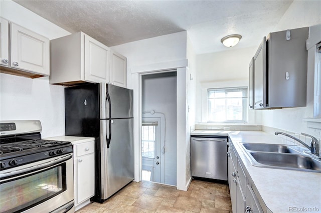 3336 N Saint Paul St, Denver, CO 80205 - kitchen featuring appliances with stainless steel finishes, a sink, light countertops, white cabinets, and stone finish floors