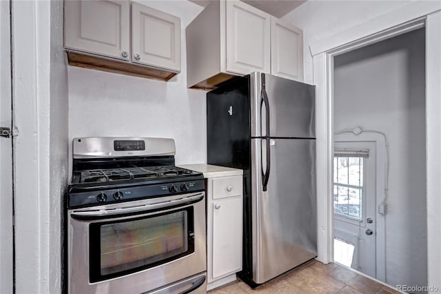 3336 N Saint Paul St, Denver, CO 80205 - kitchen featuring appliances with stainless steel finishes, white cabinetry, light countertops, and light tile patterned floors