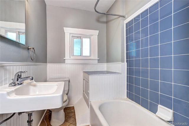3336 N Saint Paul St, Denver, CO 80205 - full bath with a tub, tile patterned flooring, toilet, a wainscoted wall, and a shower